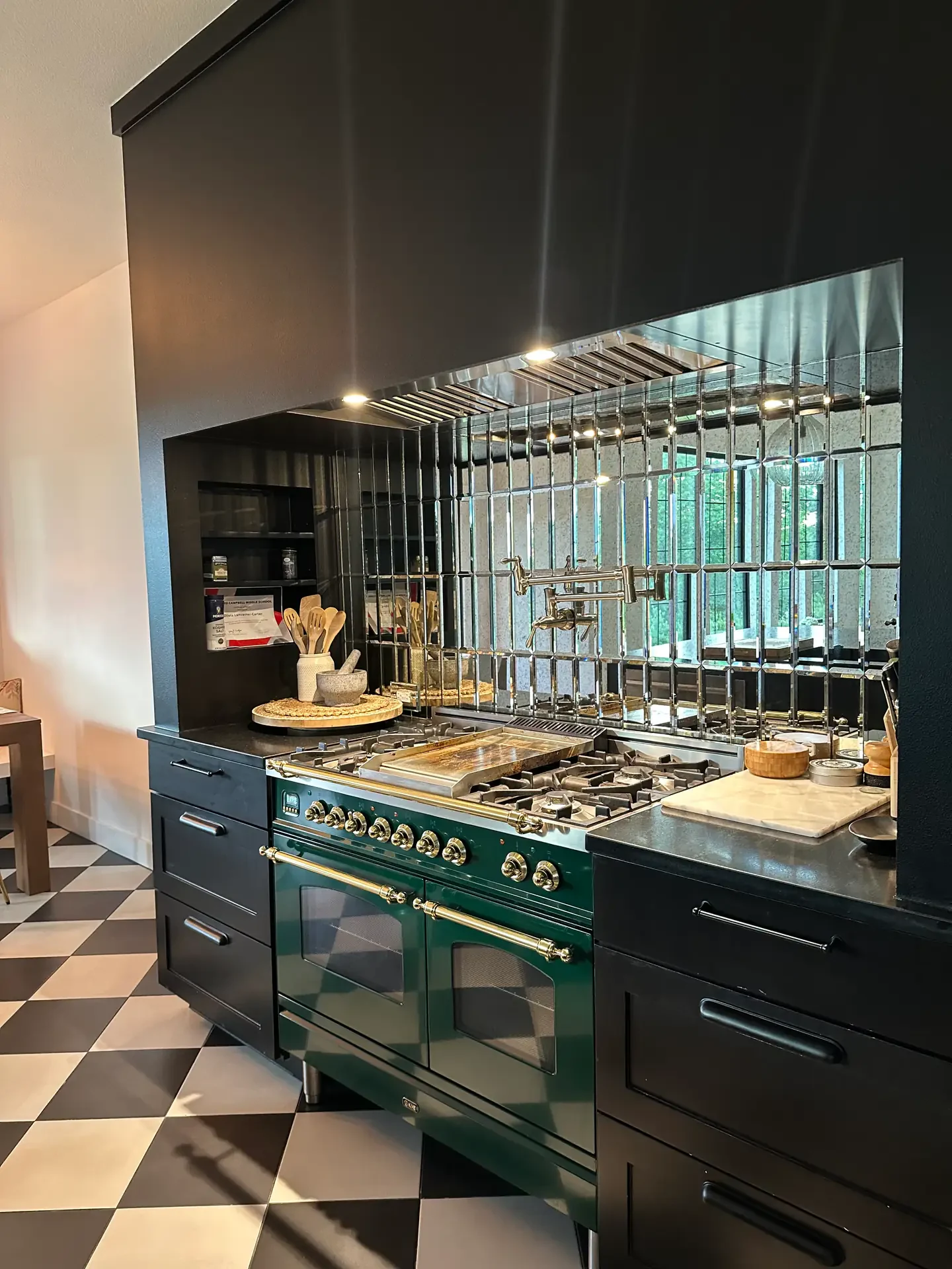Kitchen with a green range and dark cabinetry