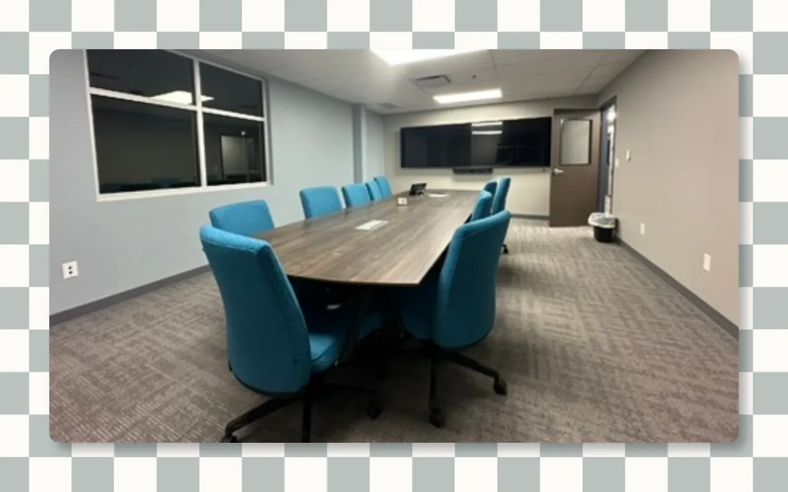 Conference room with a long table and blue chairs