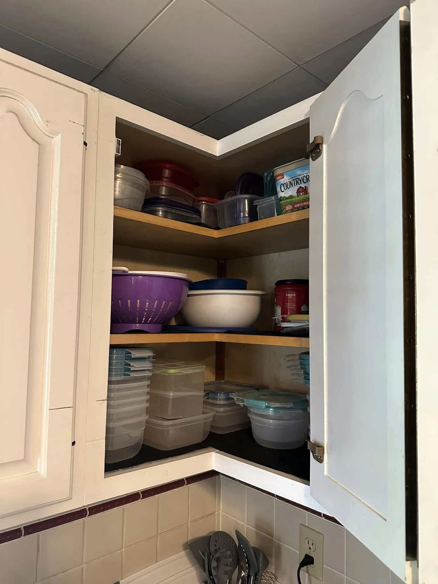 Kitchen cabinet with organized bowls and cookware